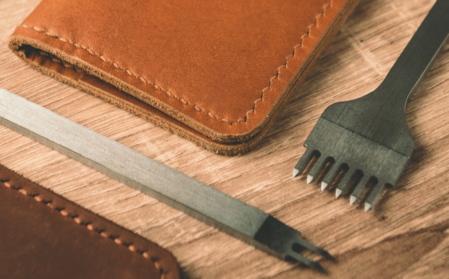 Leatherworking tools, thread and a wallet on a workbench